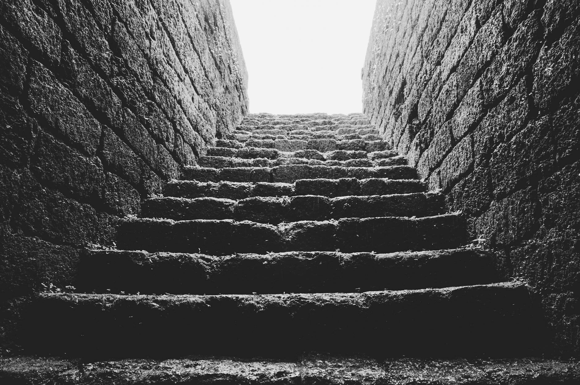 low angle grayscale photo of empty brick stairs